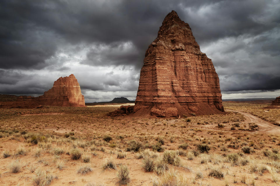 Temple of the Moon sandstone monolith in Cathedral Valley Capitol Reef National Park Utah under dark storm clouds