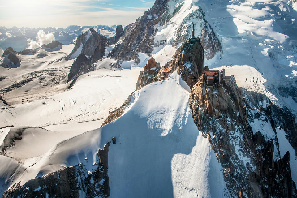 Aiguille du Midi summit above glaciers and peaks in the Mont Blanc Massif near Chamonix.