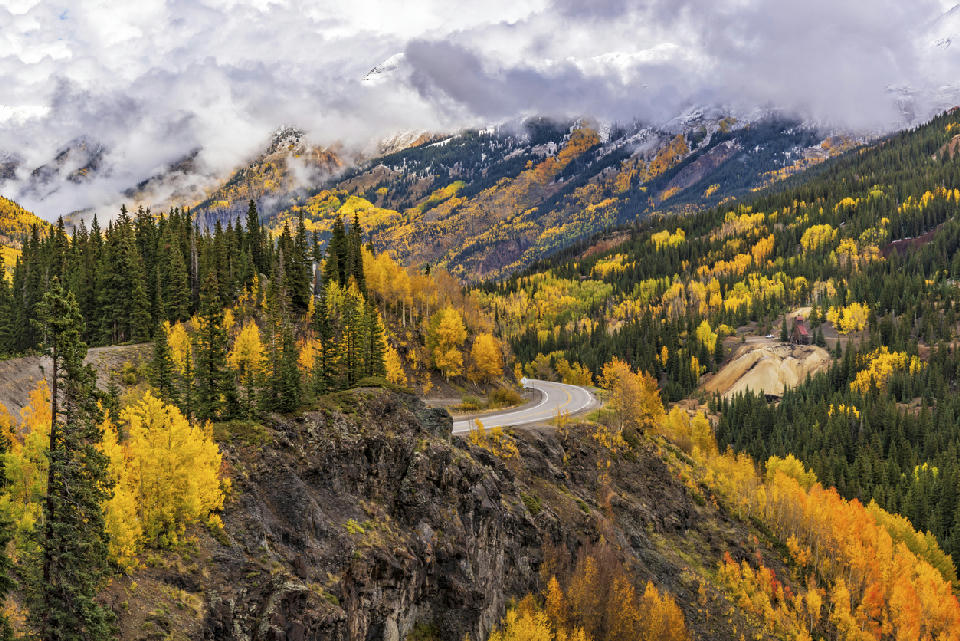 Autumn aspens and winding road at Red Mountain Pass on the Million Dollar Highway near Silverton, Colorado.