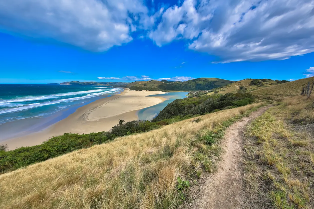 Mbotyi River Mouth estuary, beach and coastal hills viewed from an elevated hillside on the Wild Coast, Eastern Cape, South Africa.