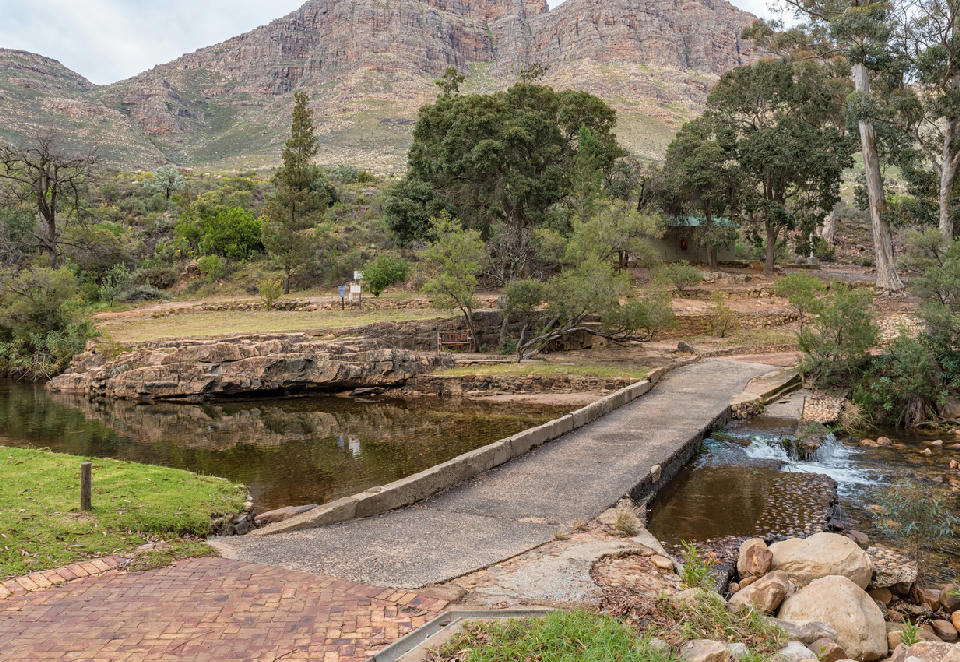 Low-water bridge crossing the Palmiet River at Algeria in the Cederberg Mountains, surrounded by indigenous trees and rugged sandstone cliffs in the Western Cape, South Africa.