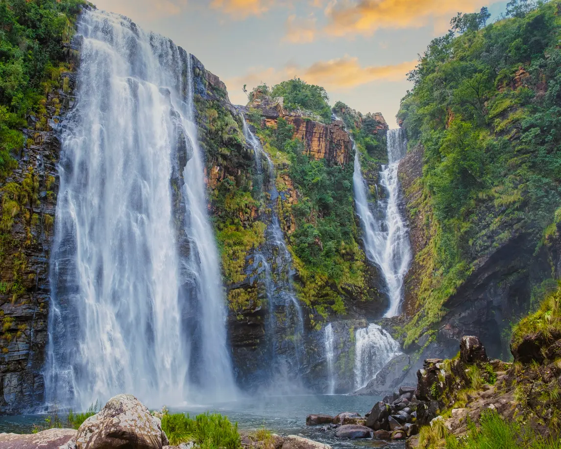 Lisbon Falls on the Panorama Route in Mpumalanga, showing the 94-metre waterfall cascading into a rocky pool surrounded by forested cliffs.