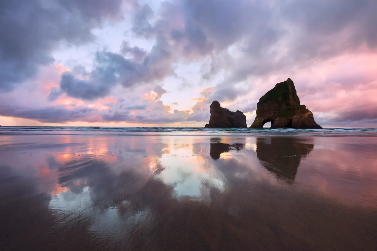 Wharariki Beach and Archway Islands at sunset, South Island, New Zealand