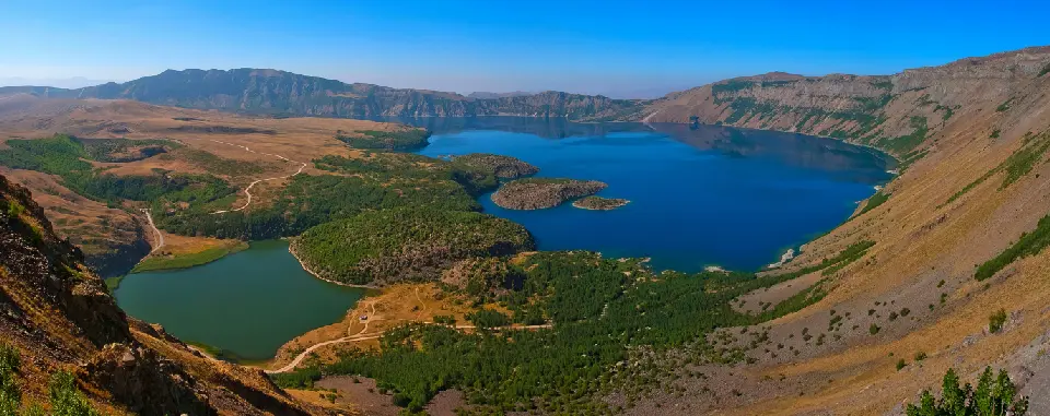 Panoramic view of deep blue Nemrut Crater Lake and smaller lakes within the volcanic caldera near Tatvan, eastern Turkey.