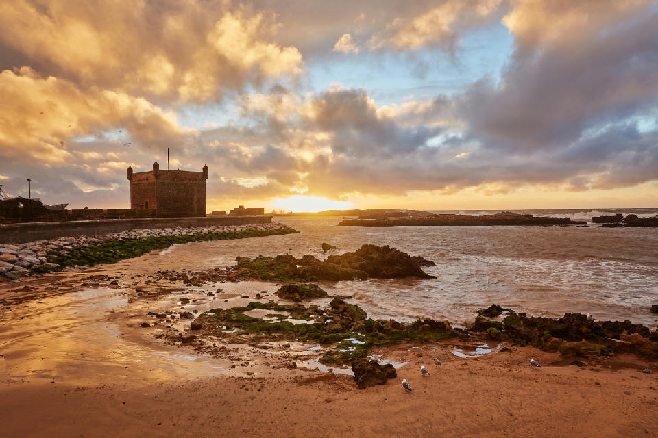 Sunset over the fortified Atlantic walls of Essaouira along Morocco’s rocky coastline