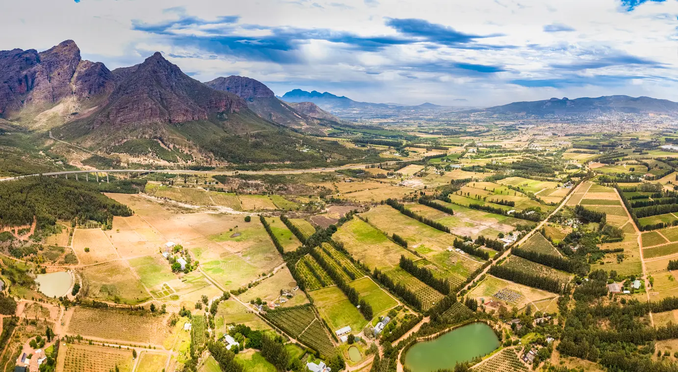 Panoramic aerial view of Paarl Valley vineyards and farmland near Du Toitskloof Pass in the Cape Winelands, Western Cape, South Africa.