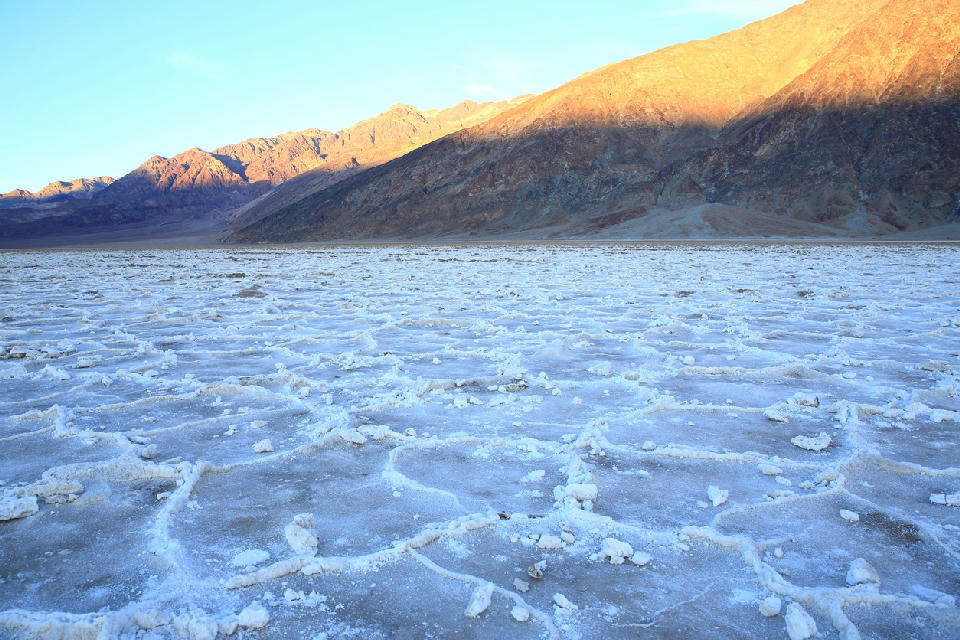 Badwater Basin salt flats polygon patterns Death Valley California sunset