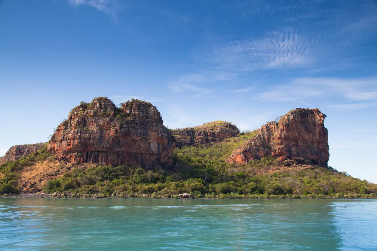 Rugged sandstone cliffs rise above the turquoise waters of the Hunter River in the remote Kimberley.
