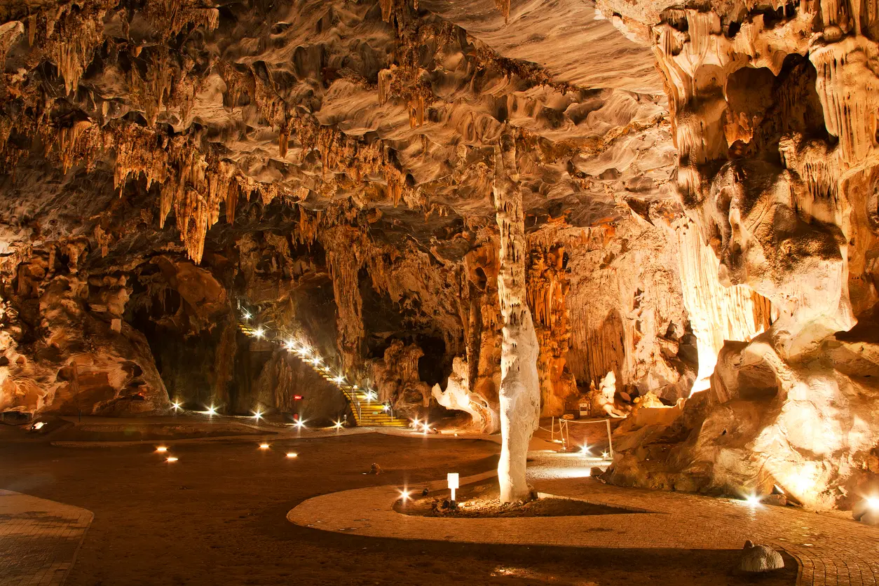 Illuminated limestone formations inside the Throne Room chamber of the Cango Caves near Oudtshoorn in the Klein Karoo region of South Africa.