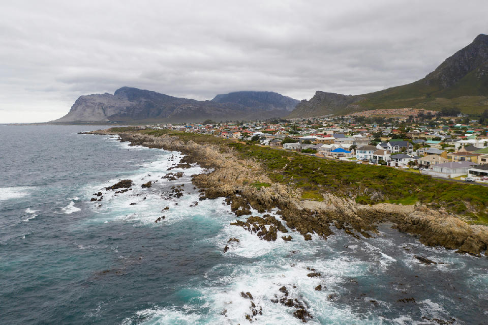 Aerial view of Kleinmond’s rocky coastline beneath the Kogelberg mountains in South Africa