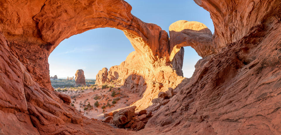 Double Arch sandstone formation framing desert landscape in Arches National Park Utah