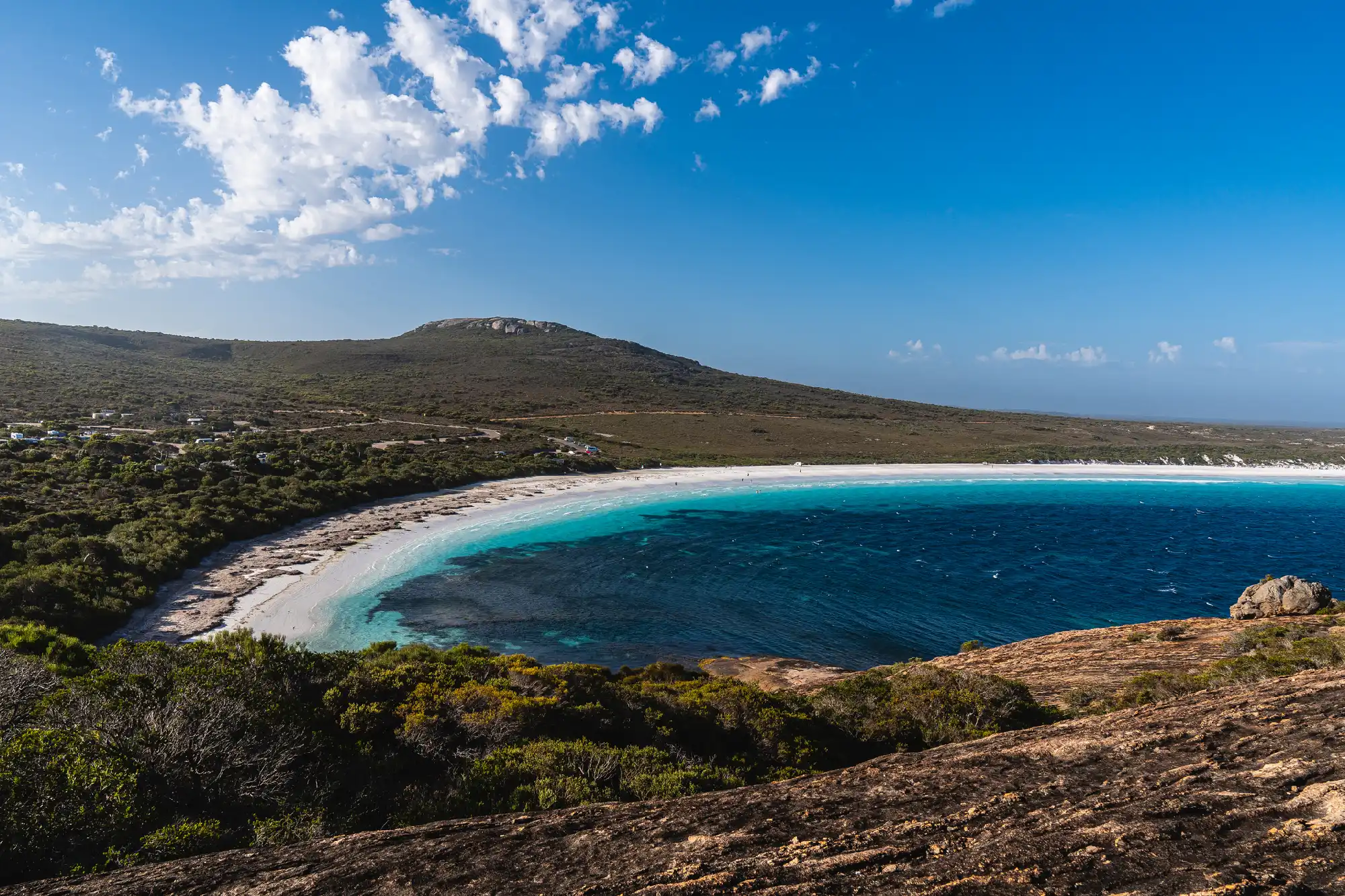 Elevated view over the white sand, turquoise water and granite landscape of Hellfire Bay in Cape Le Grand National Park, Western Australia.
