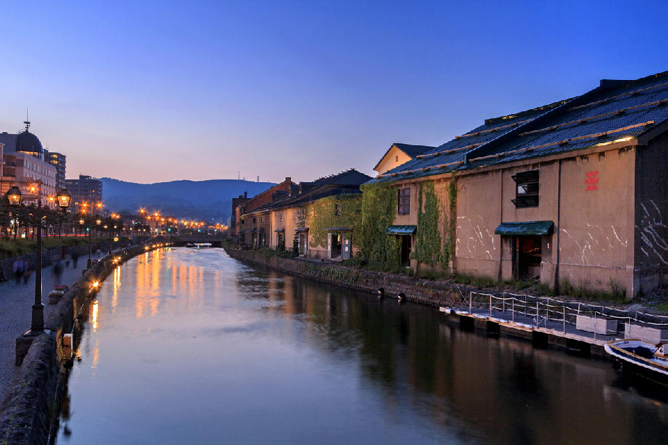 Evening view of Otaru Canal with historic warehouses and streetlights reflecting in the water, Otaru, Hokkaido.