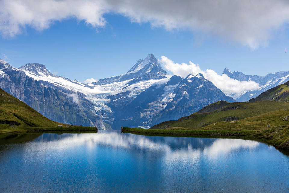 Bachalpsee reflecting snow-covered peaks and glaciers above Grindelwald in the Bernese Oberland, Switzerland.