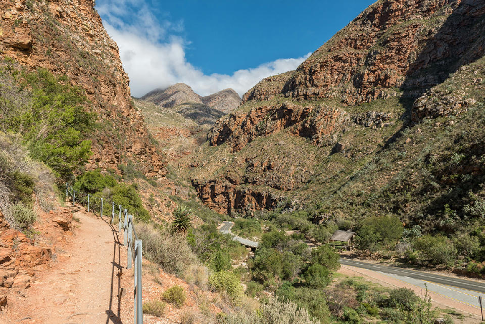 Trail leading to the Meiringspoort Waterfall above the N12 road within the dramatic red sandstone canyon landscapes of Meiringspoort in the Swartberg Mountains of South Africa.
