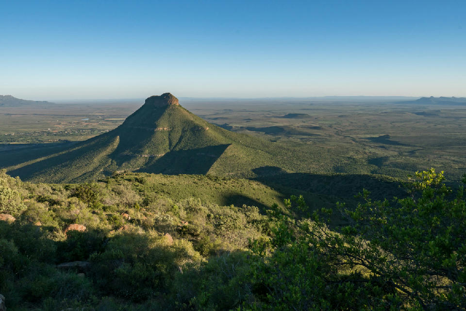Conical mountain and expansive Karoo plains viewed from Camdeboo National Park near Graaff-Reinet in the Eastern Cape, South Africa.