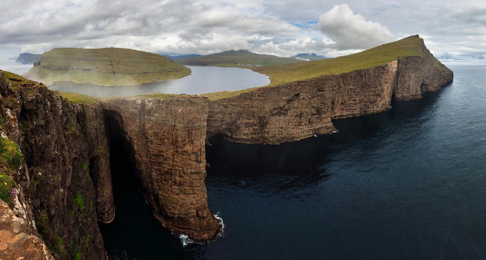 Trælanípa cliff above Leitisvatn, also called Sørvágsvatn, showing the steep drop to the Atlantic Ocean that creates the famous optical illusion on Vágar Island in the Faroe Islands.