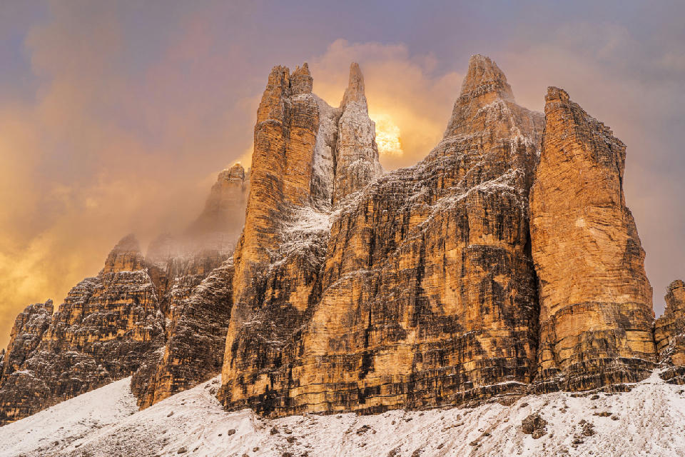 Tre Cime di Lavaredo peaks at sunrise in the Dolomites, Italy.