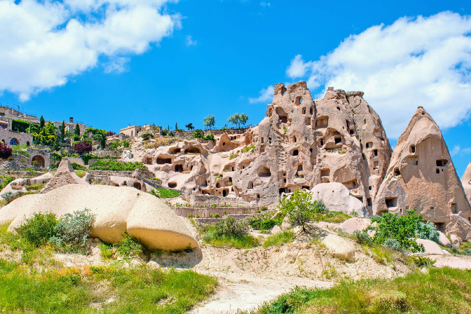 Rock-cut pigeon houses and fairy chimneys in Pigeon Valley, Cappadocia, Turkey.