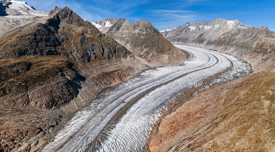 View from Bettmerhorn over the Great Aletsch Glacier curving through high alpine ridges in Valais, Switzerland.