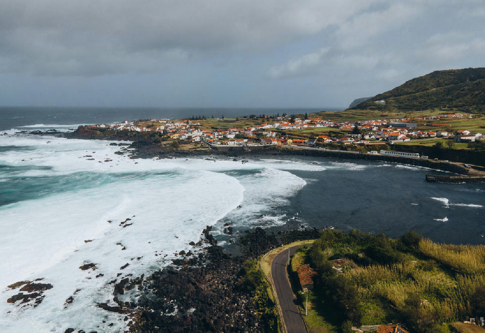 Drone view of Mosteiros village, rocky volcanic coastline and Atlantic surf on São Miguel Island in the Azores.