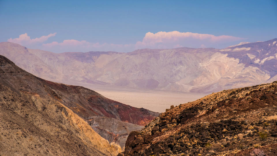 Layered desert canyon landscape from Father Crowley Overlook in Death Valley showing ridges and distant Panamint Mountains