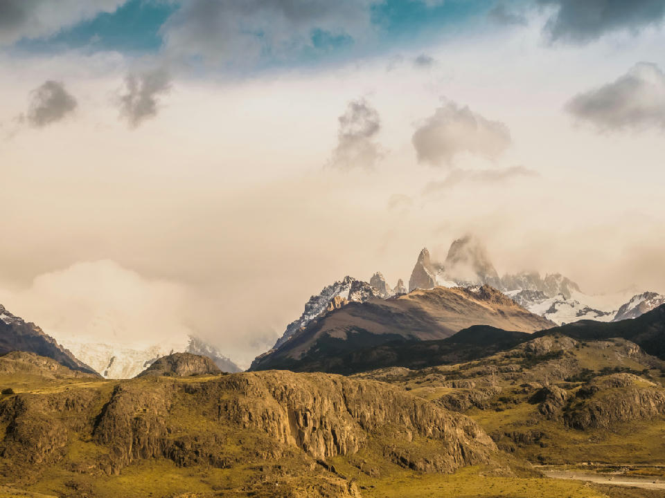 Mount Fitz Roy partially covered by clouds seen from Mirador de los Cóndores above El Chaltén in Patagonia, Argentina.