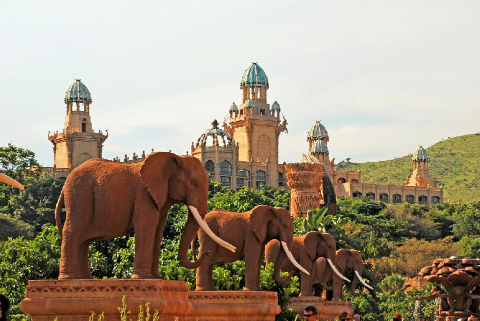 Elephant statues on the Bridge of Time with the Palace of the Lost City in the background at Sun City, North West Province.