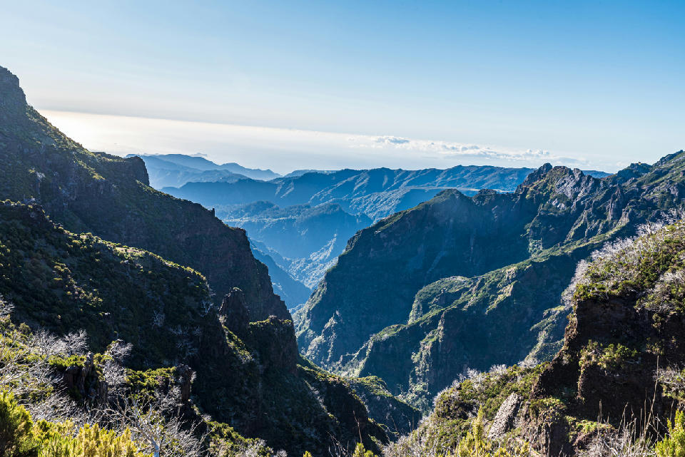 View across volcanic mountain ridges from the Vereda do Areeiro (PR1) hiking trail between Pico do Areeiro and Pico Ruivo, Madeira, Portugal.