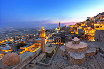Historic stone city of Mardin at blue hour overlooking the Mesopotamian plains in southeastern Turkey.