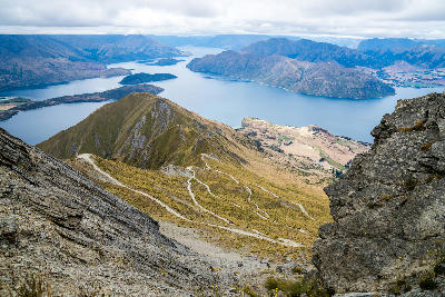 Panoramic view from Roys Peak Track overlooking Lake Wanaka and alpine mountains near Wanaka, New Zealand.
