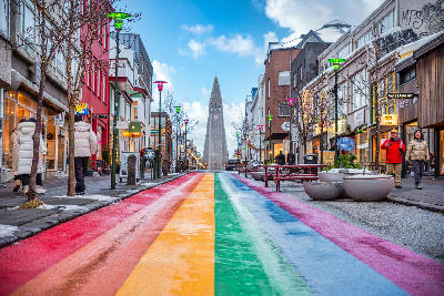 View along Rainbow Street (Skólavörðustígur) in downtown Reykjavík, with Hallgrímskirkja church visible in the background.