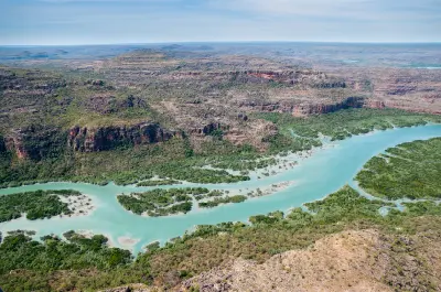 Aerial view of turquoise channels winding through mangroves between Porosus Creek and Naturalist Island in Prince Frederick Harbour.