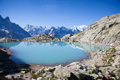 Turquoise Lac Blanc lake with reflections of Mont Blanc and alpine peaks near Chamonix in the French Alps.