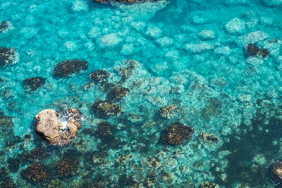 Clear turquoise water with visible rocks underwater in natural coastal environment at Cape Kamui, Kozakicho, Japan
