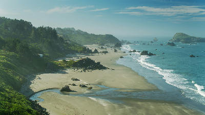Aerial view of sandbar, shoreline, and sea stacks at Lone Ranch Beach near Harris Beach, Oregon Coast.