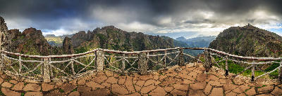 Panoramic view of Madeira’s central mountains from Miradouro do Ninho da Manta on the PR1 Vereda do Areeiro trail, Portugal.