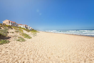Beachfront houses and dunes along Wilderness Beach on the Garden Route in the Western Cape, South Africa.