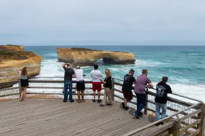 Visitors at the viewing platform overlooking London Arch in Port Campbell National Park.