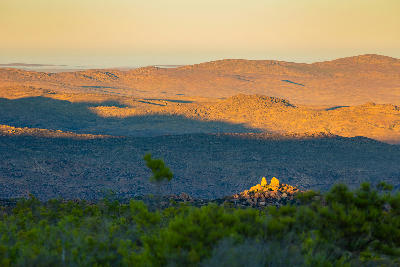 Sunrise casting long shadows across the mountain ranges and semi-arid landscapes of Namaqualand, South Africa.