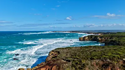 Aerial view of The Grotto coastline with limestone cliffs and Southern Ocean waves near Peterborough, Victoria.