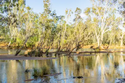 Shallow waters of the Drysdale River wind between sandy banks, eucalyptus trees and native vegetation in the Kimberley.