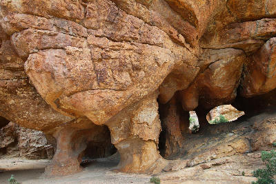 Massive sandstone pillars and naturally eroded cave chambers inside Stadsaal Caves in the Cederberg Wilderness Area, Western Cape, South Africa.