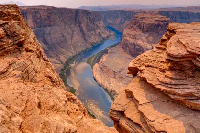 Horseshoe Bend canyon showing the Colorado River meander between steep sandstone cliffs near Page Arizona