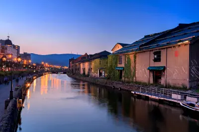 Evening view of Otaru Canal with historic warehouses and streetlights reflecting in the water, Otaru, Hokkaido.