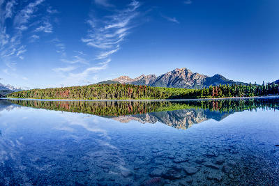 Patricia Lake with colorful forest and Pyramid Mountain reflected in calm water
