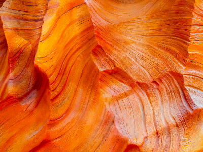 Close-up of layered sandstone texture inside Antelope Canyon showing fine striations and colour variation