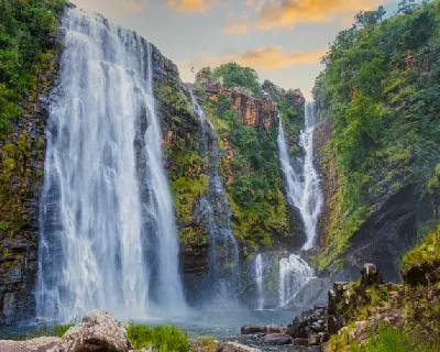 Lisbon Falls on the Panorama Route in Mpumalanga, showing the 94-metre waterfall cascading into a rocky pool surrounded by forested cliffs.