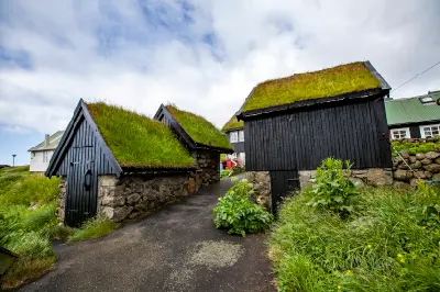 Black timber houses with grass roofs in Gásadalur village on Vágar Island, Faroe Islands.