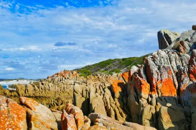 Orange lichen-covered granite formations at Eddystone Point on Tasmania’s northeast coast.